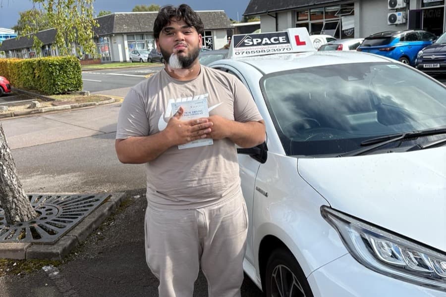 Passed learner with their driving test pass certificate
