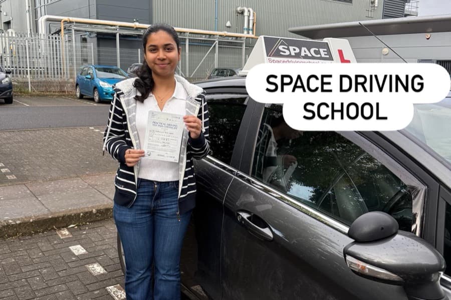 Learner showing their pass certificate after driving lessons